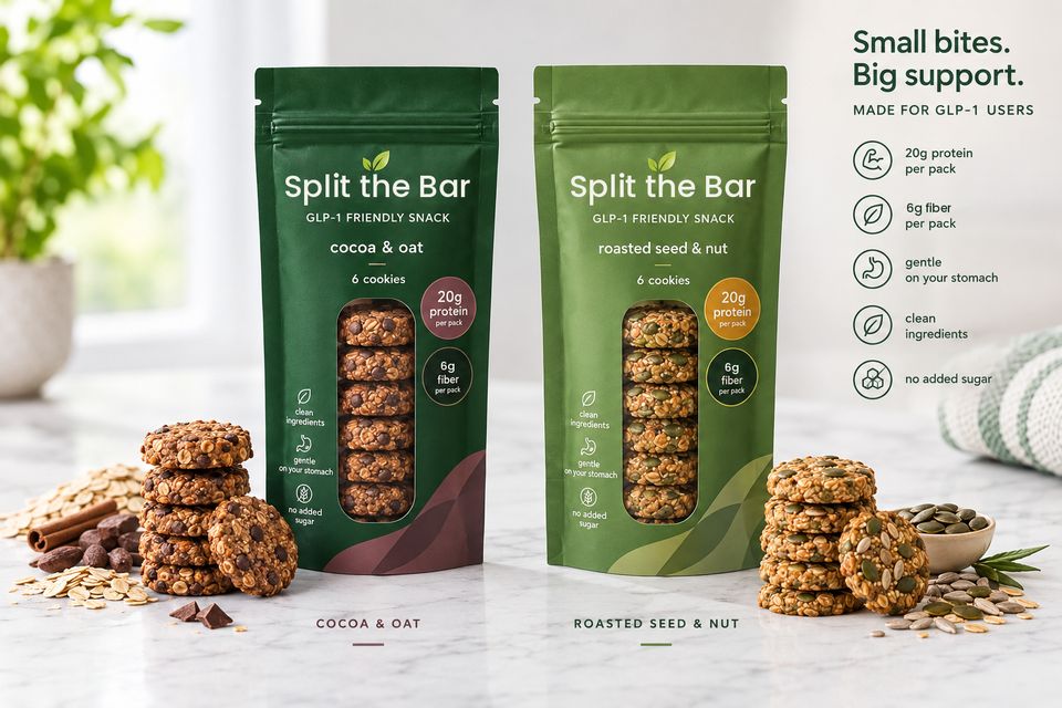 Two Split the Bar pouches, cocoa & oat and roasted seed & nut, each with six stacked cookies